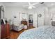 Spacious bedroom with wood floors, and comfortable chair with ottoman at 5143 Lochmead Ter, Zephyrhills, FL 33541