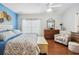 Cozy bedroom with a large window, wood floors, dresser, and decorative accent chair at 5143 Lochmead Ter, Zephyrhills, FL 33541