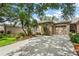 Inviting home with well-kept lawn, garden, and attached garage, offering great curb appeal at 5143 Lochmead Ter, Zephyrhills, FL 33541