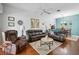 Inviting living room with cozy seating, wood flooring, and view into dining area at 5143 Lochmead Ter, Zephyrhills, FL 33541