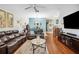 Comfortable living space with hardwood floors, plush seating, and view into dining area at 5143 Lochmead Ter, Zephyrhills, FL 33541