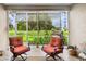 Relaxing screened patio with comfortable seating, a dining table, and a view of the backyard at 5143 Lochmead Ter, Zephyrhills, FL 33541