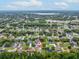 An aerial view of a home in a neighborhood with a lake in the distance at 6043 Piedmont Dr, Spring Hill, FL 34606