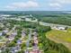 An aerial view of a home with a tree lined neighborhood at 6043 Piedmont Dr, Spring Hill, FL 34606