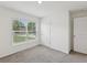 Well-lit bedroom featuring a window and neutral carpet, creating a cozy and inviting atmosphere at 6043 Piedmont Dr, Spring Hill, FL 34606