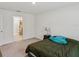 Comfortable bedroom next to bathroom with neutral walls and plush carpet at 6043 Piedmont Dr, Spring Hill, FL 34606