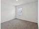Neutral bedroom with a carpeted floor and a window allowing natural light to fill the space at 6043 Piedmont Dr, Spring Hill, FL 34606