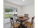 Cozy dining area featuring a round wood table, comfortable chairs, and sliding glass doors to the patio at 6043 Piedmont Dr, Spring Hill, FL 34606