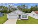 Charming single-story home with well-manicured lawn and attached two-car garage at 6043 Piedmont Dr, Spring Hill, FL 34606