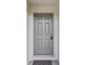 Elegant front door with a secure lock system and gray trim at 6043 Piedmont Dr, Spring Hill, FL 34606