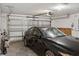 Clean, organized garage with vehicle, tools, and white door at 6043 Piedmont Dr, Spring Hill, FL 34606