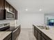 Spacious kitchen featuring stainless steel appliances and granite countertops at 6043 Piedmont Dr, Spring Hill, FL 34606