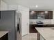 Modern kitchen with stainless steel appliances, granite countertops, and dark wood cabinetry at 6043 Piedmont Dr, Spring Hill, FL 34606