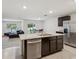 Open kitchen layout with a center island, stainless steel appliances, and a view of the living area at 6043 Piedmont Dr, Spring Hill, FL 34606