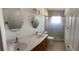 Bathroom featuring double sinks, a granite countertop, and glass shower at 6474 29Th N Ave, St Petersburg, FL 33710