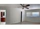 Bright bedroom featuring a ceiling fan, window with blinds, and access to an ensuite bathroom with cherry cabinets at 6474 29Th N Ave, St Petersburg, FL 33710