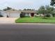 Charming single-story home with a well-maintained lawn, a two-car garage, and a welcoming red front door at 6474 29Th N Ave, St Petersburg, FL 33710