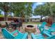 Outdoor patio with dining and seating areas, a fire pit, and a playground beyond at 670 42Nd Ne Ave, St Petersburg, FL 33703