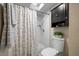 Bright bathroom featuring a shower, toilet, and black wall storage at 670 42Nd Ne Ave, St Petersburg, FL 33703