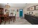 Open dining area with natural light, stylish light fixture, shutters and wood-look floors at 670 42Nd Ne Ave, St Petersburg, FL 33703