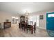Spacious dining room seamlessly connects to the kitchen, featuring an elegant chandelier and modern flooring at 670 42Nd Ne Ave, St Petersburg, FL 33703