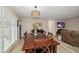 Cozy dining area with wooden furniture, stylish lighting, shutters and seamless connection to living area at 670 42Nd Ne Ave, St Petersburg, FL 33703