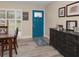 Warm entryway with a striking blue door, wood-look floors, and elegant furniture at 670 42Nd Ne Ave, St Petersburg, FL 33703