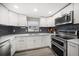 Contemporary kitchen with white cabinetry, modern appliances, and a sleek backsplash at 670 42Nd Ne Ave, St Petersburg, FL 33703