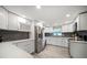 Bright kitchen with white cabinetry, stainless steel appliances, and modern countertops at 670 42Nd Ne Ave, St Petersburg, FL 33703