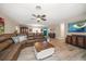 Comfortable living room features a large sectional sofa, wood-look flooring, and a ceiling fan at 670 42Nd Ne Ave, St Petersburg, FL 33703