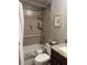 Cozy bathroom featuring a shower with modern tiles, granite countertop, and tiled walls at 701 Mirror Lake N Dr # 103, St Petersburg, FL 33701