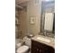 Bathroom featuring a granite countertop, updated fixtures, and a decorative shower at 701 Mirror Lake N Dr # 103, St Petersburg, FL 33701