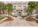 Elegant building entrance with brick walkway and palm trees at sunrise at 701 Mirror Lake N Dr # 103, St Petersburg, FL 33701