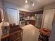 Well-lit kitchen with stainless appliances and dining table with wood finish at 701 Mirror Lake N Dr # 103, St Petersburg, FL 33701