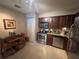 Efficient kitchen featuring stainless steel appliances, a dining table, and wood cabinets at 701 Mirror Lake N Dr # 103, St Petersburg, FL 33701