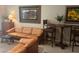 Inviting living room featuring leather sofas, accent chairs, and neutral wall color at 701 Mirror Lake N Dr # 103, St Petersburg, FL 33701