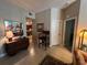 Cozy living room with tile floors, stylish furnishings, and an open view into the kitchen at 701 Mirror Lake N Dr # 103, St Petersburg, FL 33701