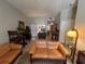 Spacious living room with tile floors, leather seating, and stylish decor at 701 Mirror Lake N Dr # 103, St Petersburg, FL 33701