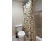 Bathroom with a toilet and a shower tub with fern shower curtain at 701 S Madison Ave # 410, Clearwater, FL 33756