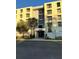 Exterior view of a multi-story condo building featuring well-maintained landscaping and clearly marked entrance at 701 S Madison Ave # 410, Clearwater, FL 33756