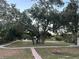 Well-maintained community grounds with trees, walking path, and pool area at 701 S Madison Ave # 410, Clearwater, FL 33756