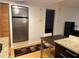Modern kitchen features stainless steel refrigerator, granite countertops, and hardwood floors at 701 S Madison Ave # 410, Clearwater, FL 33756