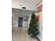 Lobby with tile flooring, high ceilings, artwork, elevator, and holiday Christmas tree at 701 S Madison Ave # 410, Clearwater, FL 33756