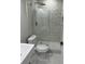 Modern bathroom with a beautiful glass door shower, marble floors, and contemporary fixtures at 7021 Parliament Dr, Tampa, FL 33619