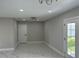 Cozy bedroom features new tile flooring, neutral paint, modern lighting, and a new back door at 7021 Parliament Dr, Tampa, FL 33619