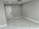 Cozy bedroom features new tile flooring, neutral paint, modern lighting, and ample closet space at 7021 Parliament Dr, Tampa, FL 33619