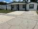 Charming single-story home with fresh exterior paint, large driveway, and a welcoming front entrance at 7021 Parliament Dr, Tampa, FL 33619