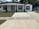Charming single-story home with fresh exterior paint, large driveway, and a welcoming front entrance at 7021 Parliament Dr, Tampa, FL 33619