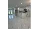 Bright kitchen featuring an island, white cabinets, modern appliances, and beautiful tile floors at 7021 Parliament Dr, Tampa, FL 33619