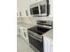 Modern kitchen featuring stainless steel appliances, quartz countertops and white shaker cabinetry at 7021 Parliament Dr, Tampa, FL 33619